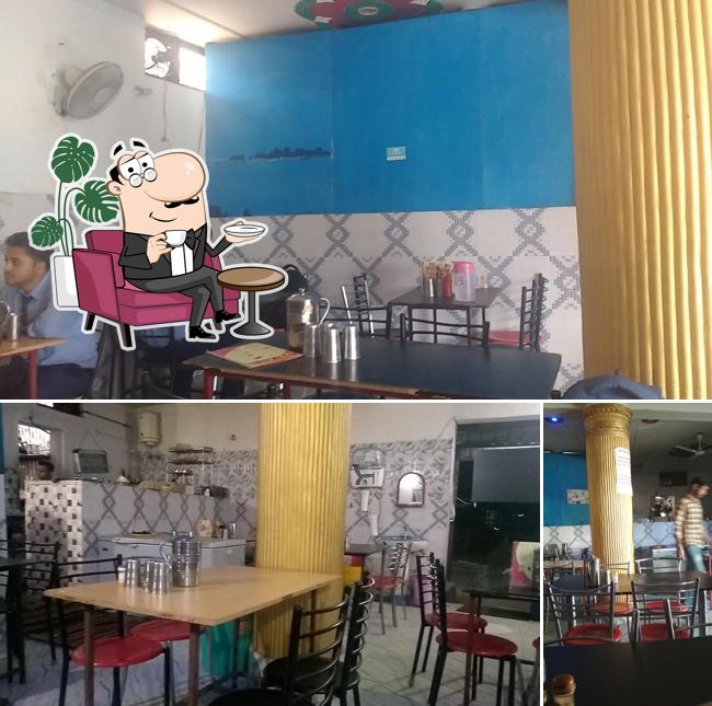 Take a seat at one of the tables at Meenakshi Restaurant