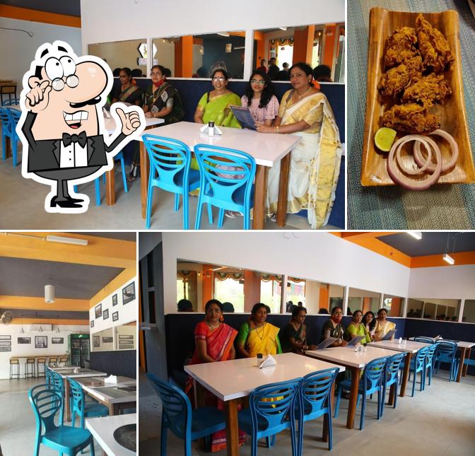 Take a seat at one of the tables at Charminar Chowrasta Restaurant and Valhalla Cafe