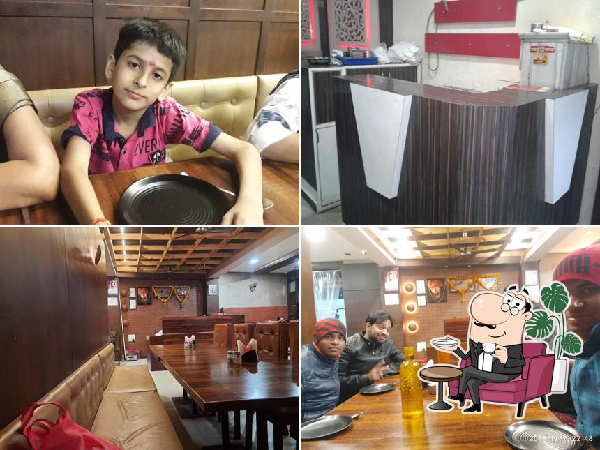 Take a seat at one of the tables at New Rajkumar Restaurant(Madhav Nagar)