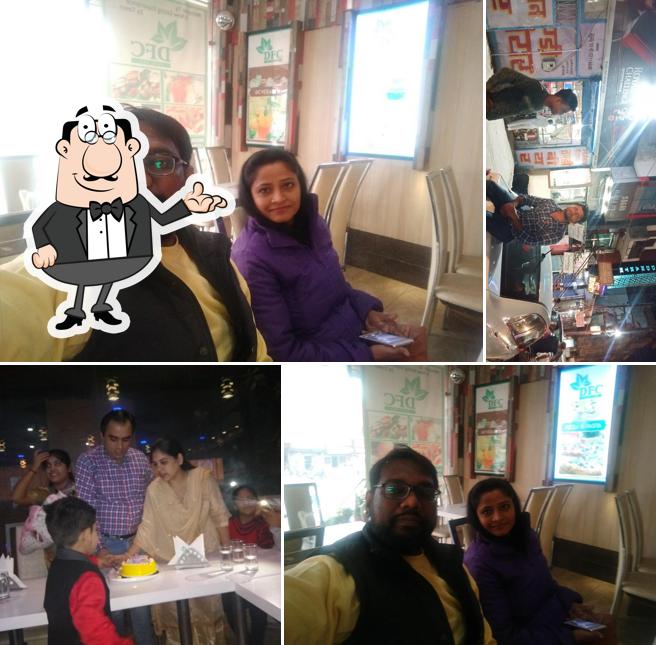 Take a seat at one of the tables at DFC Pure Veg. Restaurant