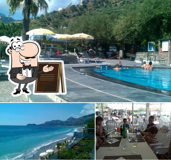 Questa è la immagine che mostra la esterno e tavolo da pranzo di Paradise Beach Club