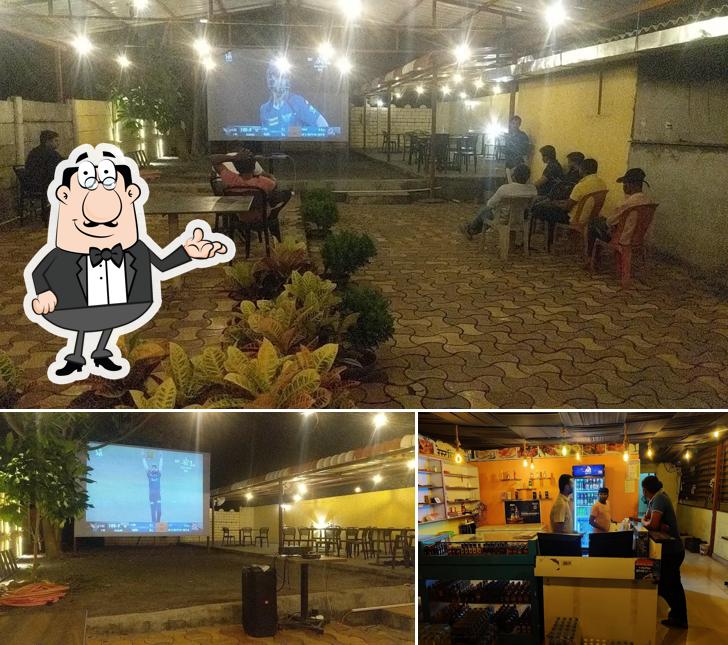 Take a seat at one of the tables at NEW AMRUTA RESTAURANT & BAR