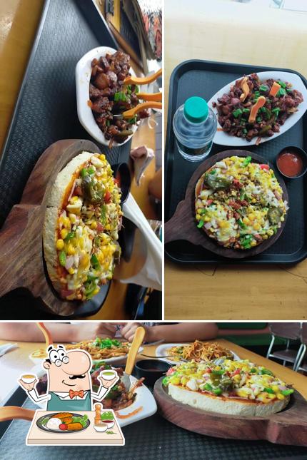 Among various things one can find food and dining table at Munchers Cafe