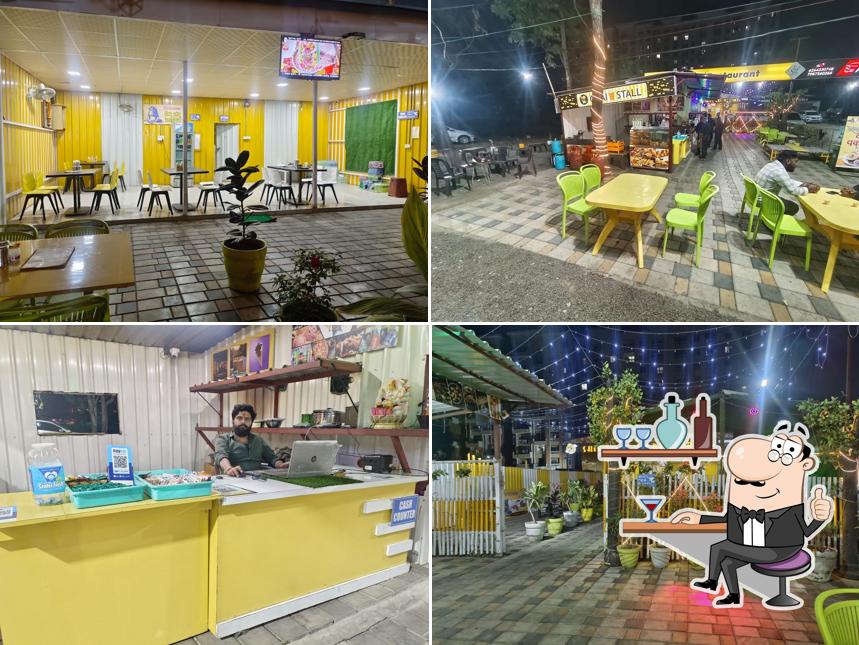 Take a seat at one of the tables at Shiv Shambhu Restaurant