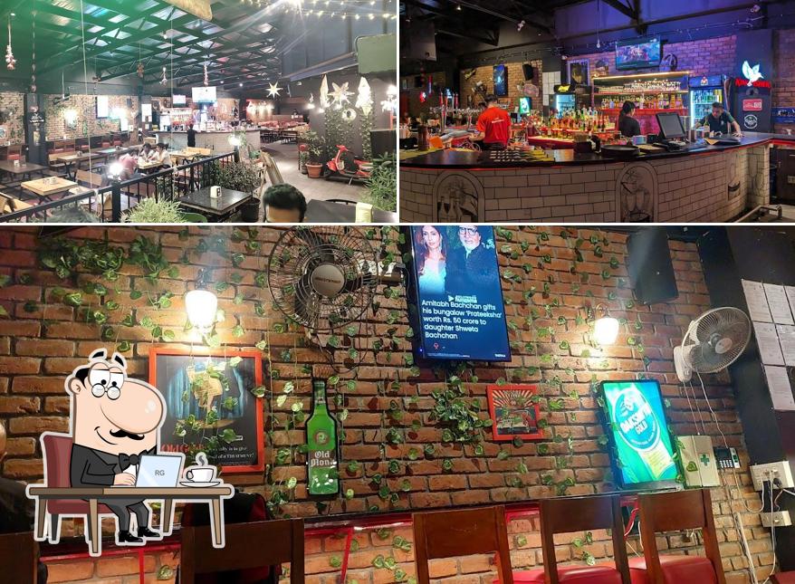 Take a seat at one of the tables at Sherlock's Lounge & Kitchen Nagarbhavi