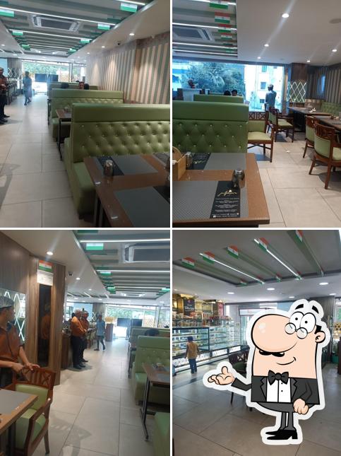 Take a seat at one of the tables at JALPAAN PURE VEG RESTAURANT