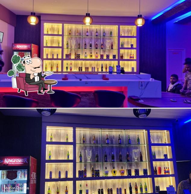 Take a seat at one of the tables at SAMRAT BAR & RESTAURANT