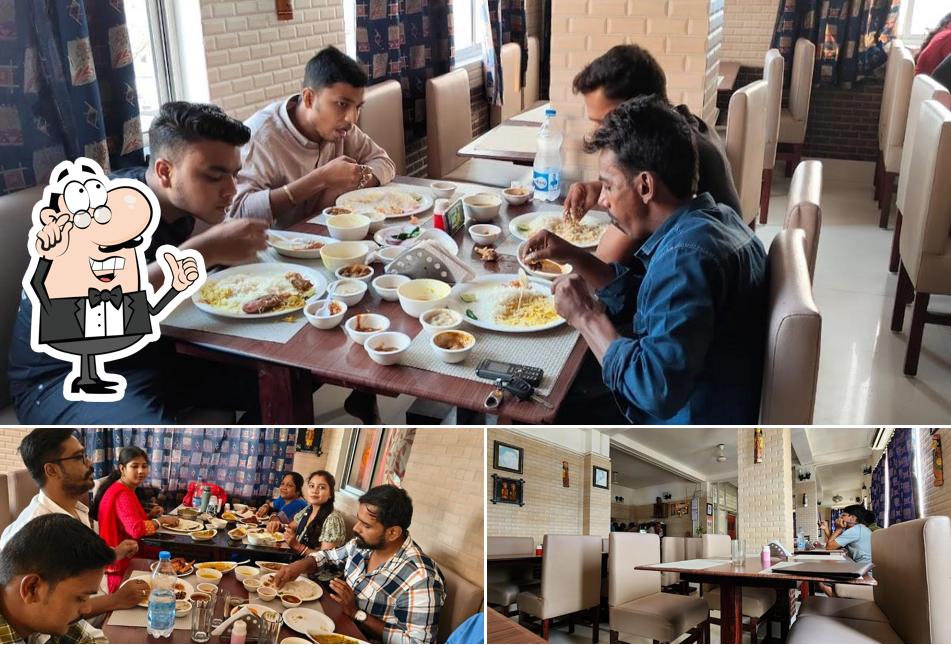 Take a seat at one of the tables at MAHABHOJ Restaurant