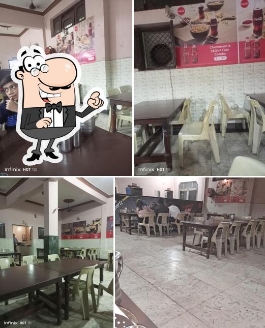 Take a seat at one of the tables at Anupam Fast Food Centre