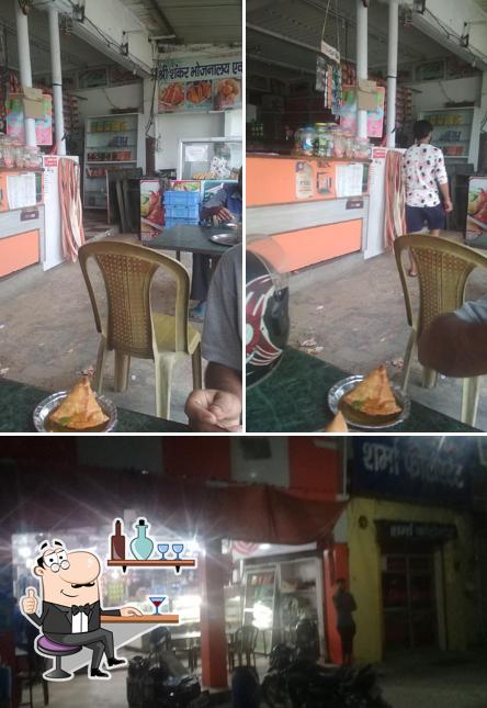 Take a seat at one of the tables at Shree Shankar Bhojnalaya & Misthan Bhandar