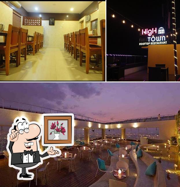 Take a seat at one of the tables at High Town (Rooftop restaurant)