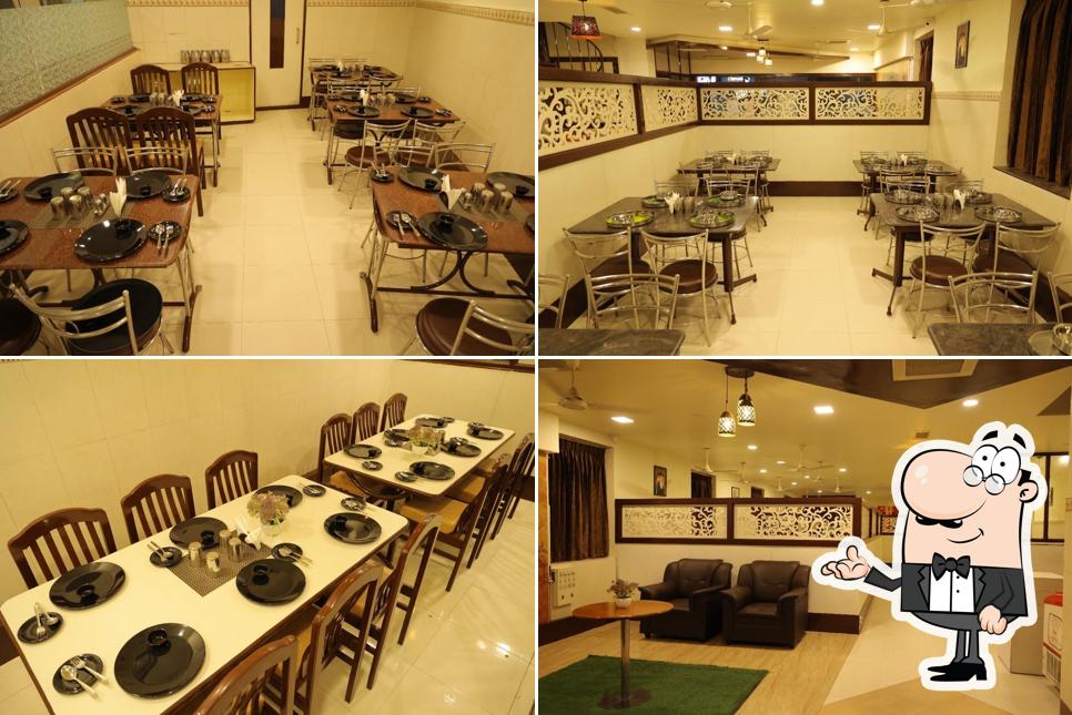 Take a seat at one of the tables at Madurai mundasukatti briyani By Kongu Classic Restaurant