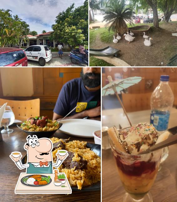 The photo of food and exterior at Aarthy Drive-Inn Restaurant