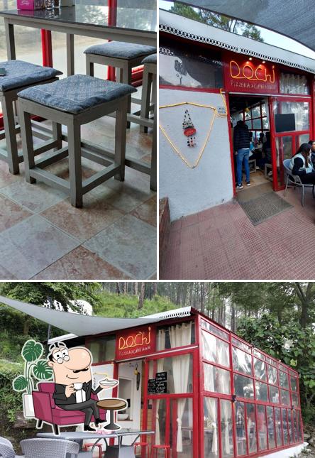 Take a seat at one of the tables at Dochi - Village Pizzeria & Coffee House - Kasauli