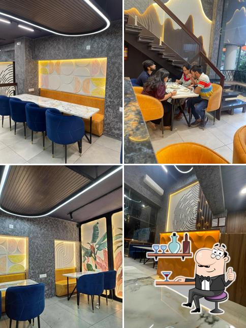Take a seat at one of the tables at Munch N Mime - Restaurant N Cafe, at Geeta Bhawan Square
