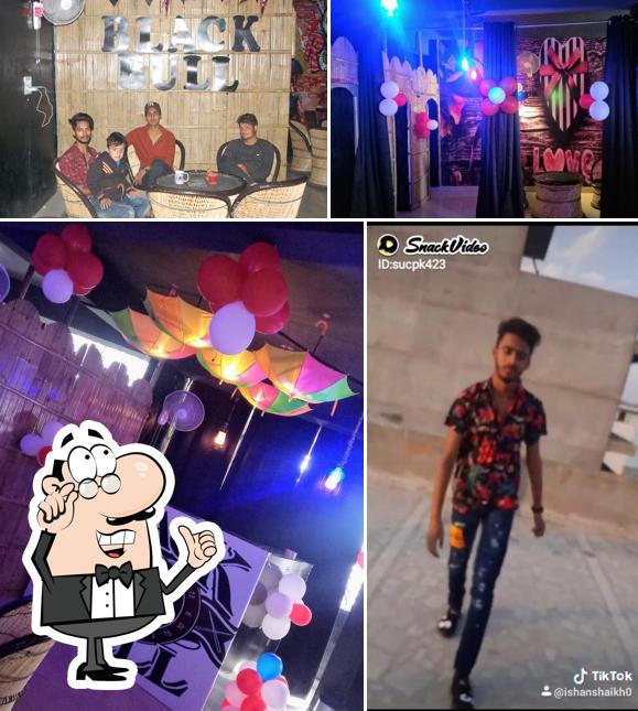 Take a seat at one of the tables at Black Bull Cafe - Best Cafe For Couples in Kota