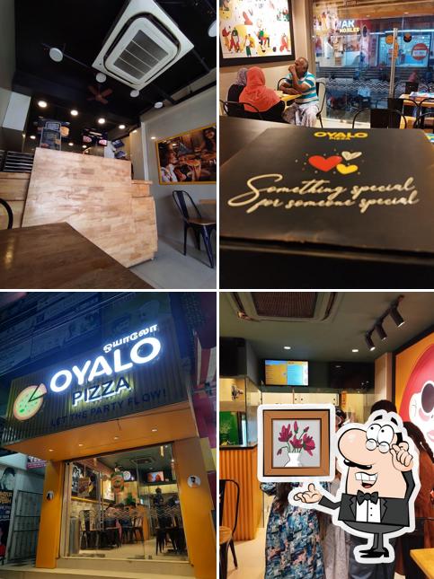 Take a seat at one of the tables at Oyalo pizza kovilpatti