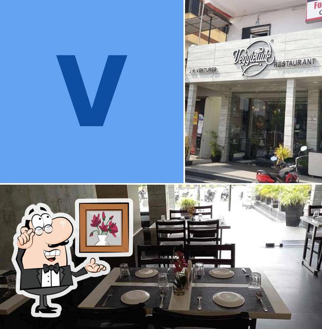 Take a seat at one of the tables at VEGGIETUDE RESTAURANT TRIMURTI NAGAR
