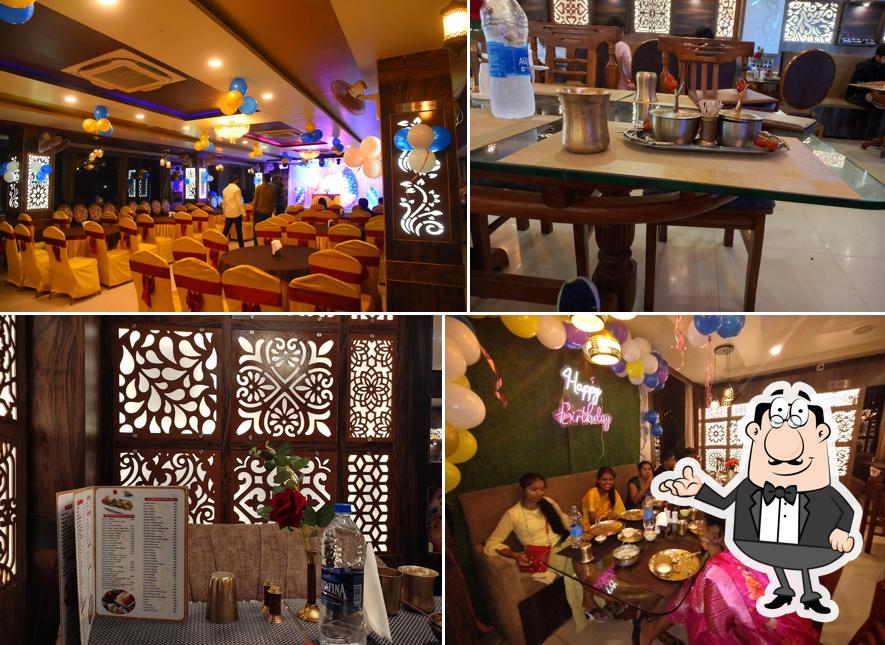Take a seat at one of the tables at Ganga Ram - Family Restaurant (Pure Veg)