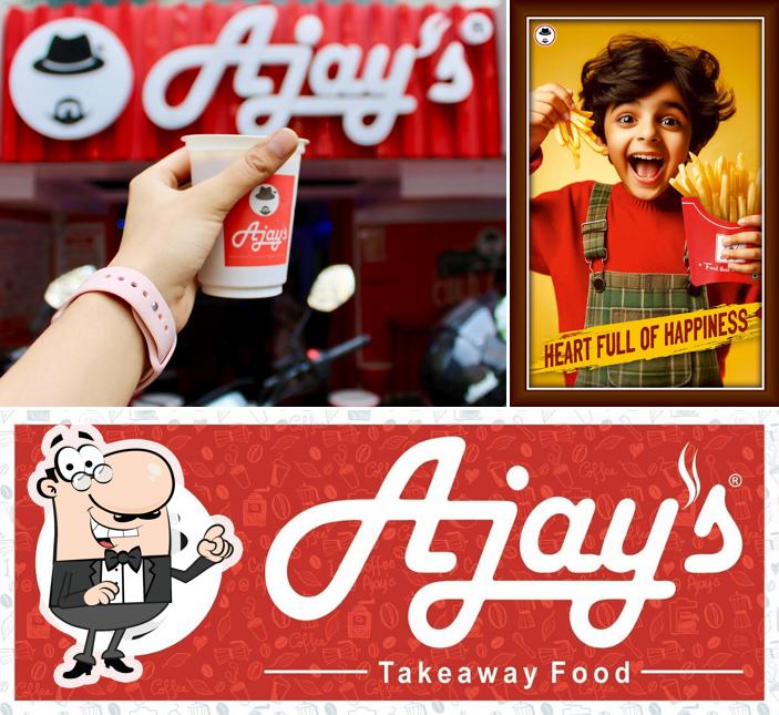 Take a seat at one of the tables at Ajay's Café City Light Surat