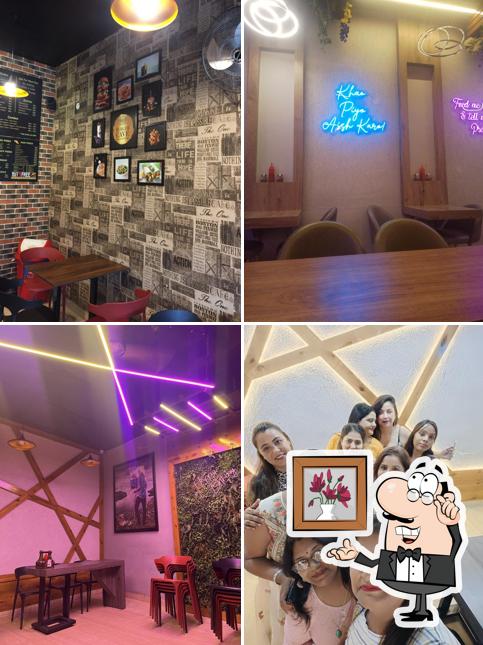Take a seat at one of the tables at BURGER CAVE (Pure Veg) -Best Burger Restaurant in Dera Bassi Best Pizza Restaurant