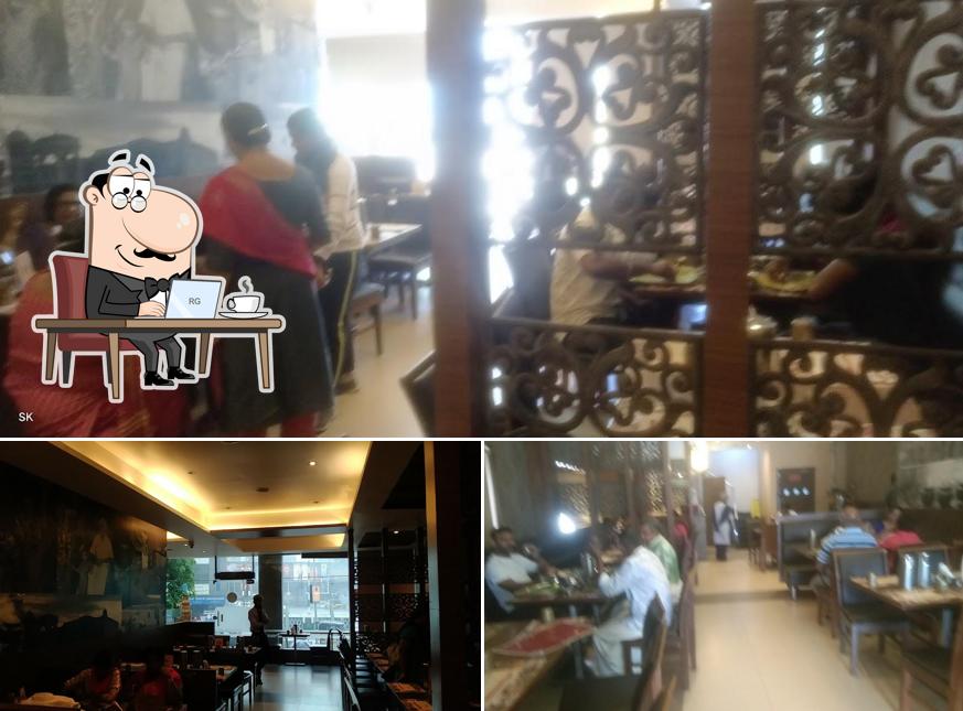 Take a seat at one of the tables at Dindigul Thalappakatti Restaurant