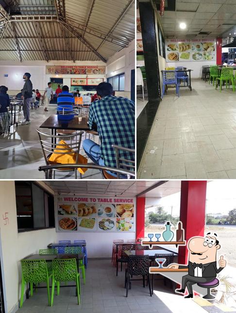 Take a seat at one of the tables at Royal Classic Family Restaurant And Fast Food