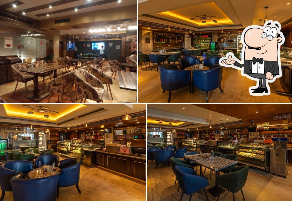 Take a seat at one of the tables at Belfrance Cafe - Bakers , Chocolatiers & Restaurant