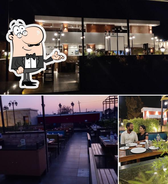 Take a seat at one of the tables at Hotel Madhuvan Veg