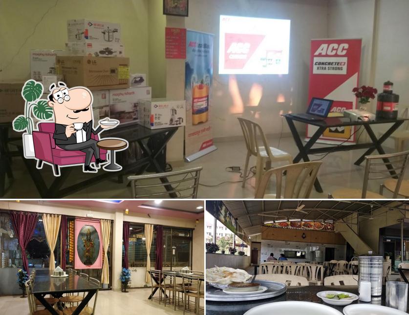 Take a seat at one of the tables at Hotel Mauli Park Veg Restaurant Karad