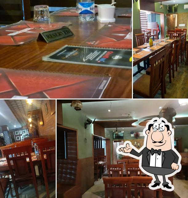 Take a seat at one of the tables at Grand inn Restaurant