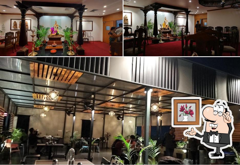 Take a seat at one of the tables at Annalakshmi Restaurant