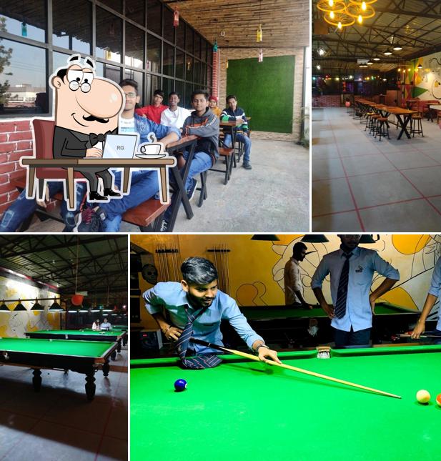 Take a seat at one of the tables at Play More Cafe