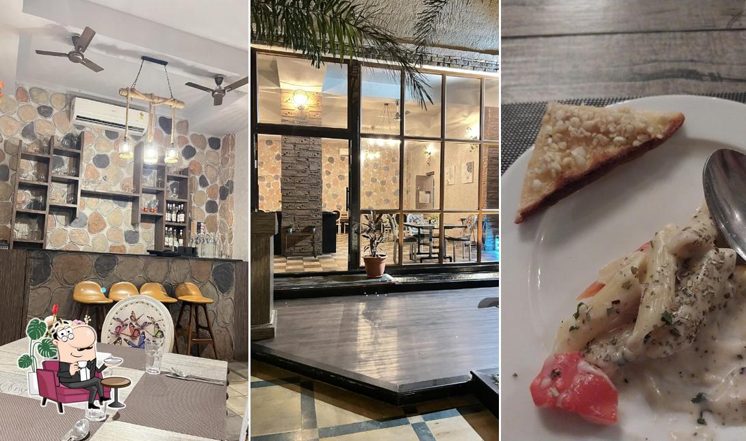 Take a seat at one of the tables at Pan Aroma: Rooftop Restaurant at The Summer House