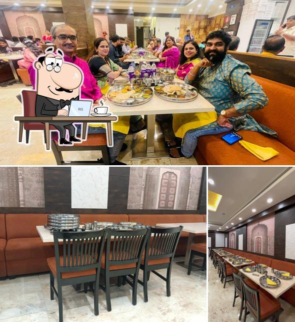 Take a seat at one of the tables at Naivedya Thali Restaurant
