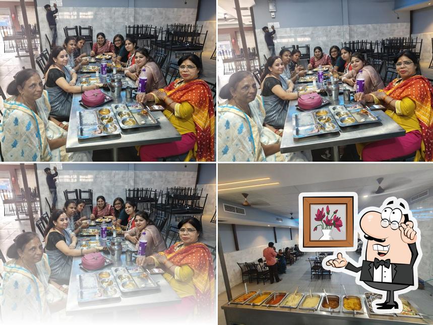 Take a seat at one of the tables at Karnawat bhojan prasadi