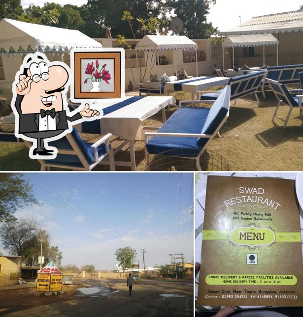 Take a seat at one of the tables at Swad Multicuisine Family Restaurant