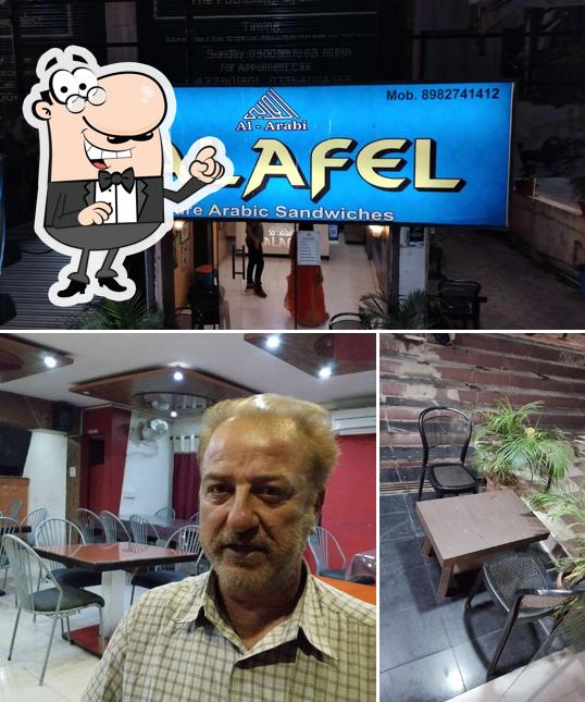 Take a seat at one of the tables at Al Arabi Falafel