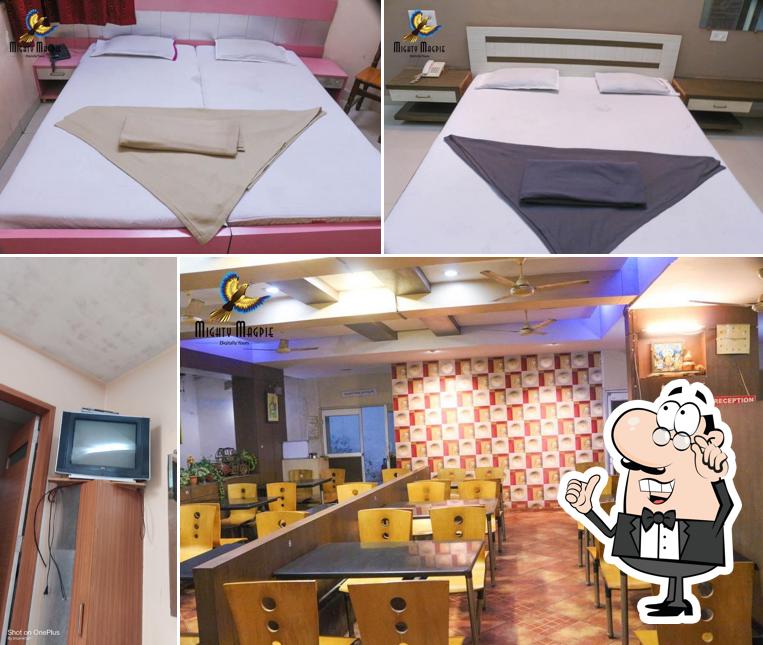 Take a seat at one of the tables at Hotel Anuradha Lodiging & Boarding