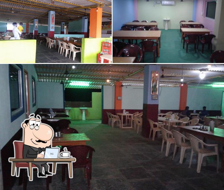 Take a seat at one of the tables at Hotel New Sai Krishna Family Restaurant