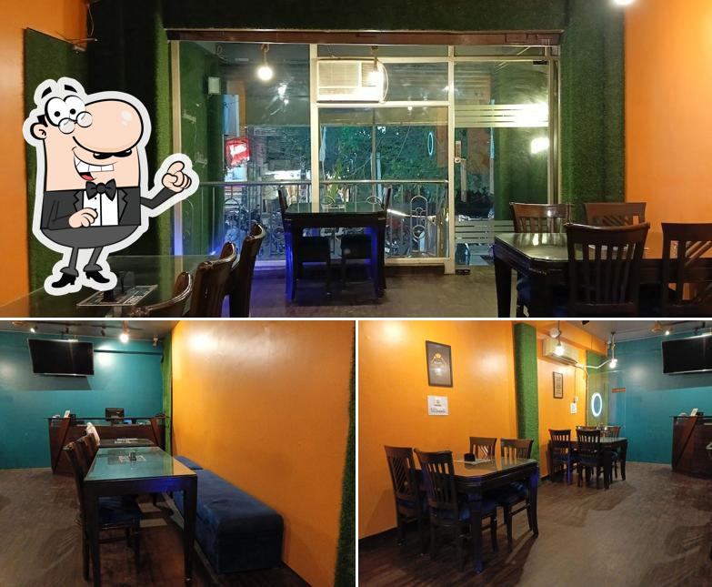 Take a seat at one of the tables at FOOD 24BY7 - Restaurant