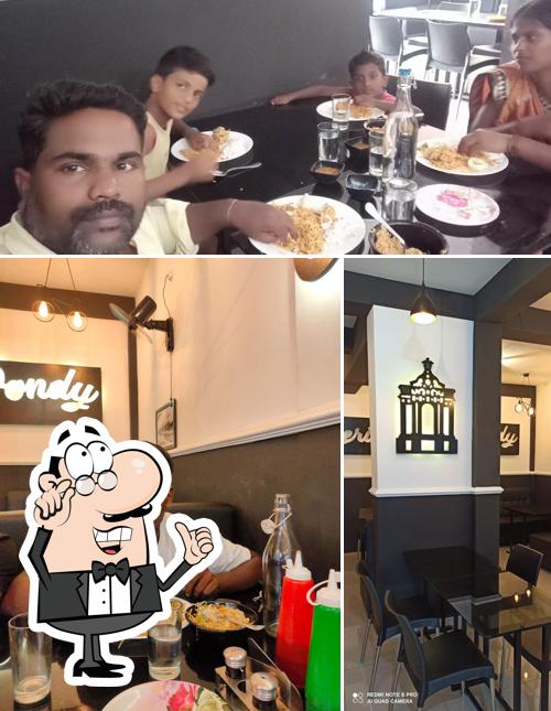 Take a seat at one of the tables at Heritage Pondy Restaurant