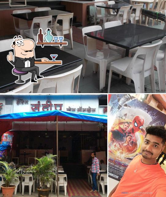 Take a seat at one of the tables at Hotel Sandeep Veg Non Veg Restaurant