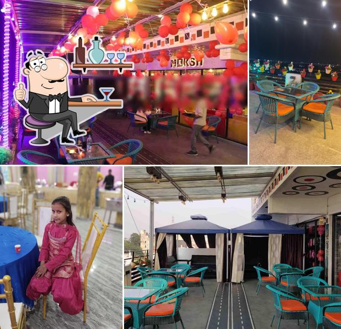 Take a seat at one of the tables at Moksh rooftop multi cuisine restaurant Take a seat at one of the tables at Moksh rooftop multi cuisine restaurant