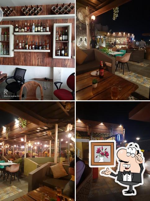 Take a seat at one of the tables at Sizzler Bar And Rooftop Restaurant