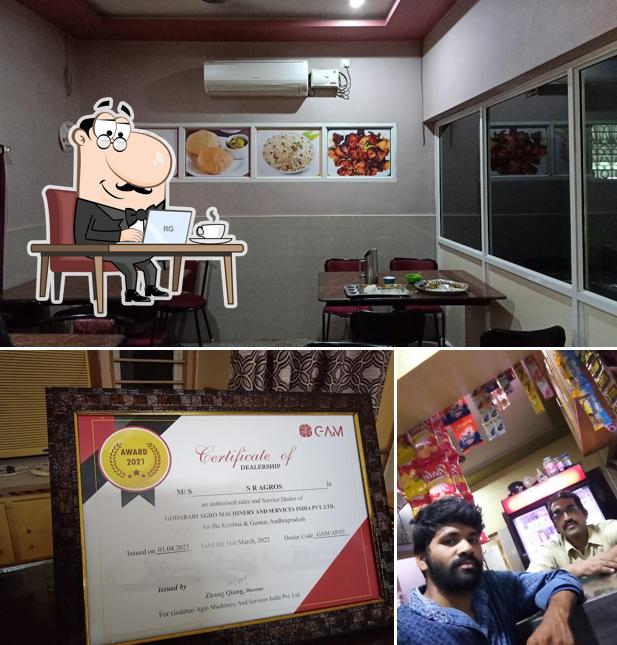 Take a seat at one of the tables at Amalodbhavi Restaurant