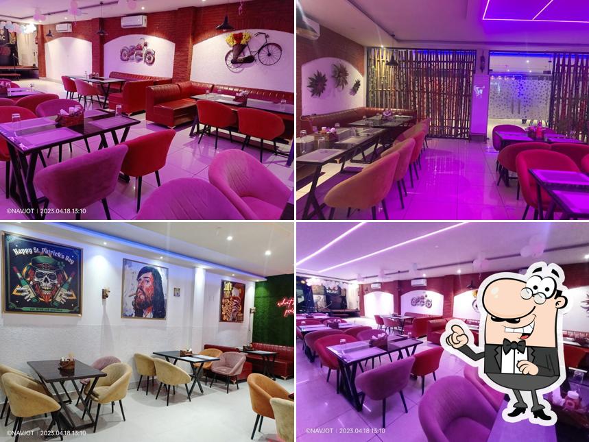 Take a seat at one of the tables at Gup Shup Adda