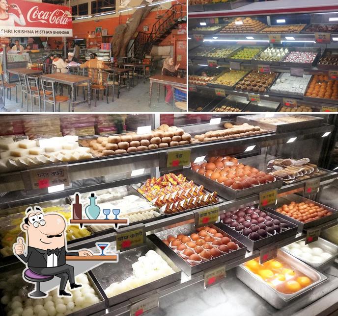 Take a seat at one of the tables at Krishna misthan Bhandar & Restaurant