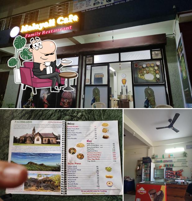 Take a seat at one of the tables at Malayali Cafe