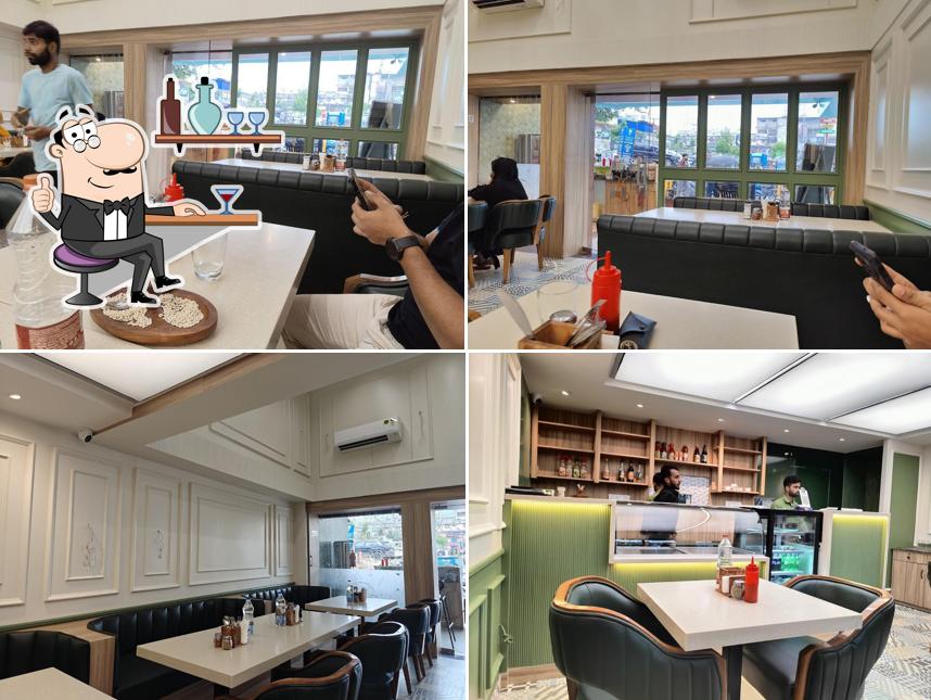 Take a seat at one of the tables at Zaitun Cafe & lounge